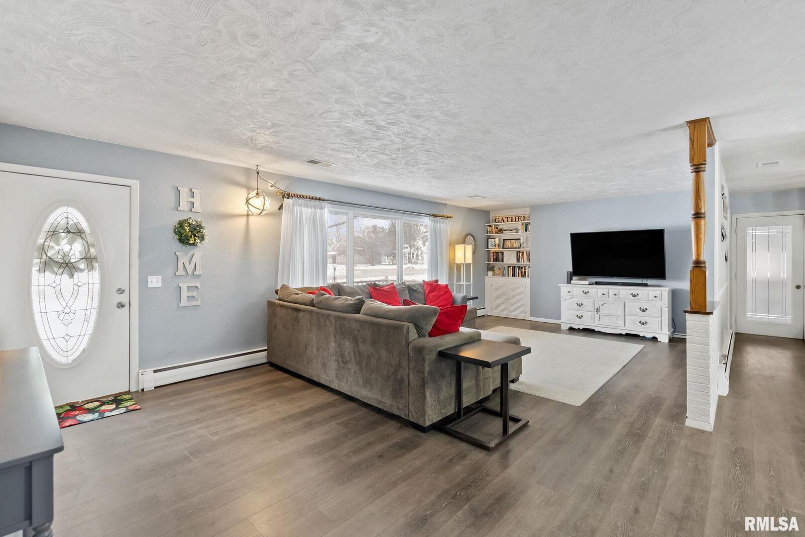 301 North Washington Street Atkinson, IL 61235 - Photo 9 of 45 a living room with furniture and a flat screen tv