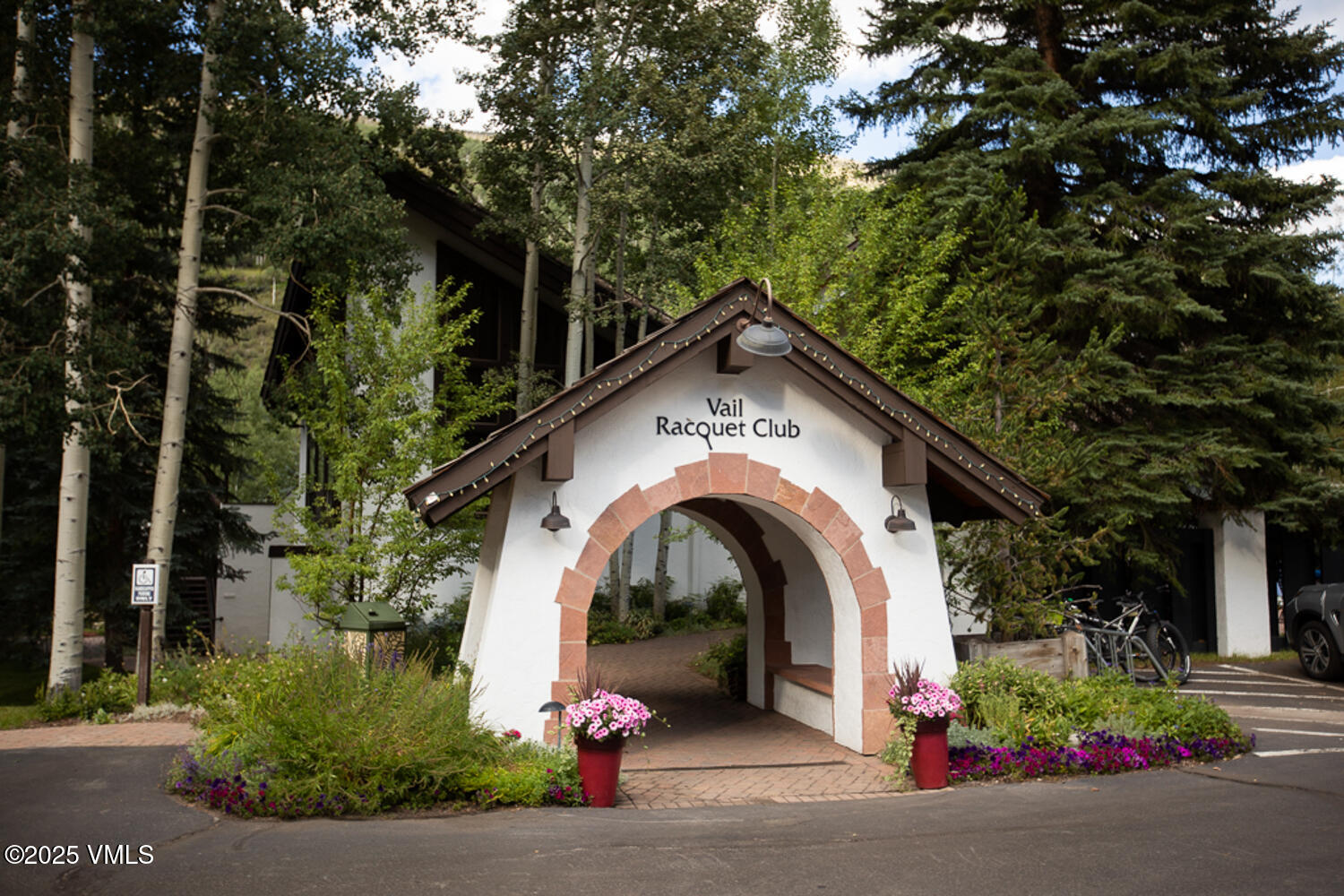 a view of a house with garage and plants