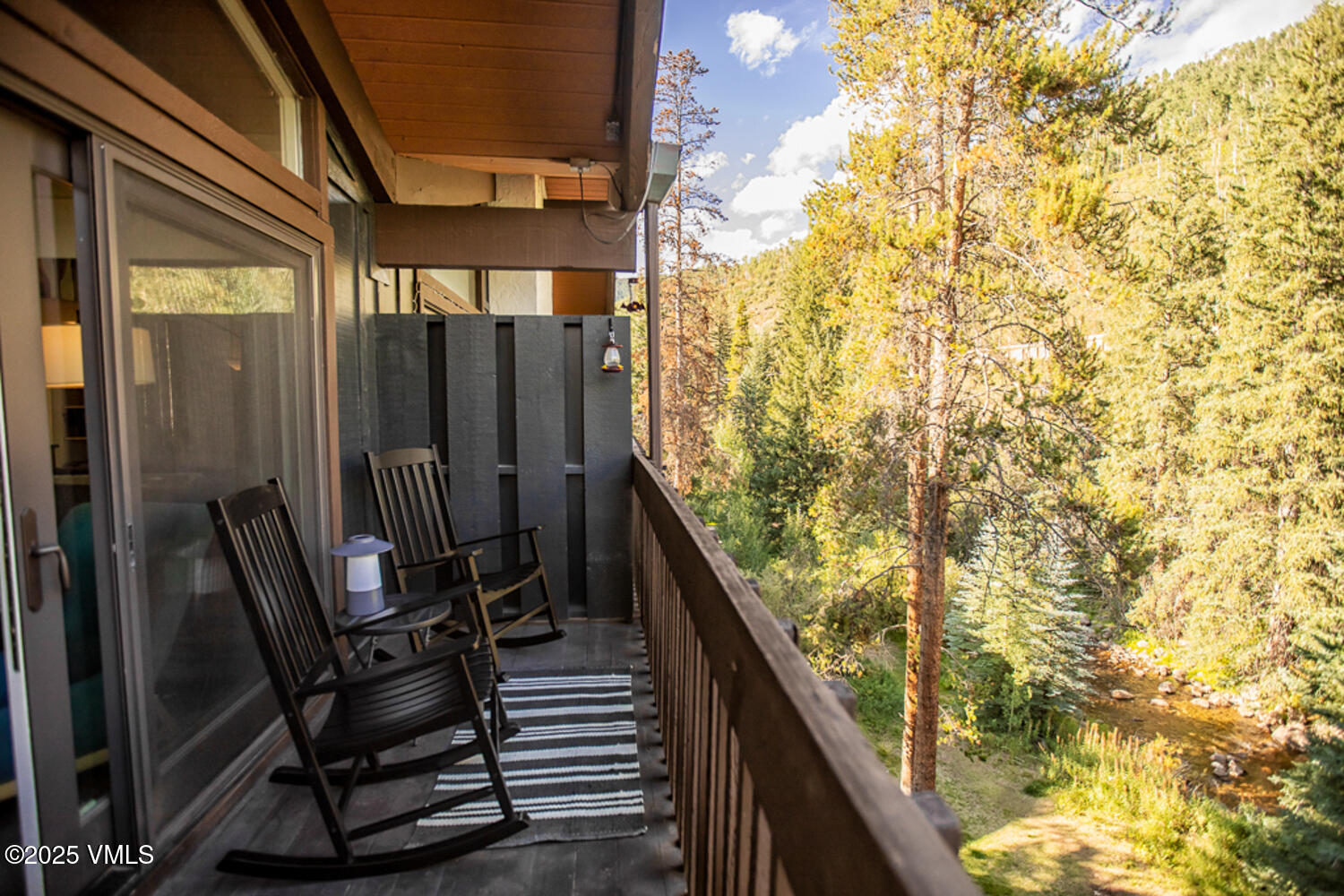 4650 Vail Racquet Club Drive, Unit 21 Vail, CO 81657 - Photo 14 of 29 a balcony view with chairs and wooden door