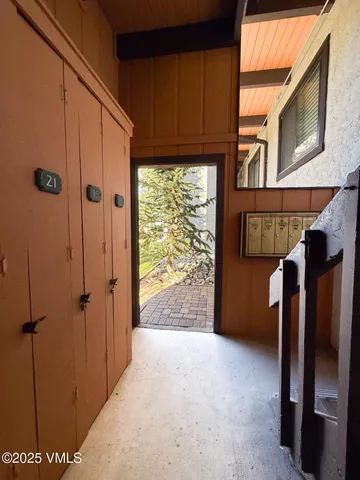 a view of a door and wooden walls