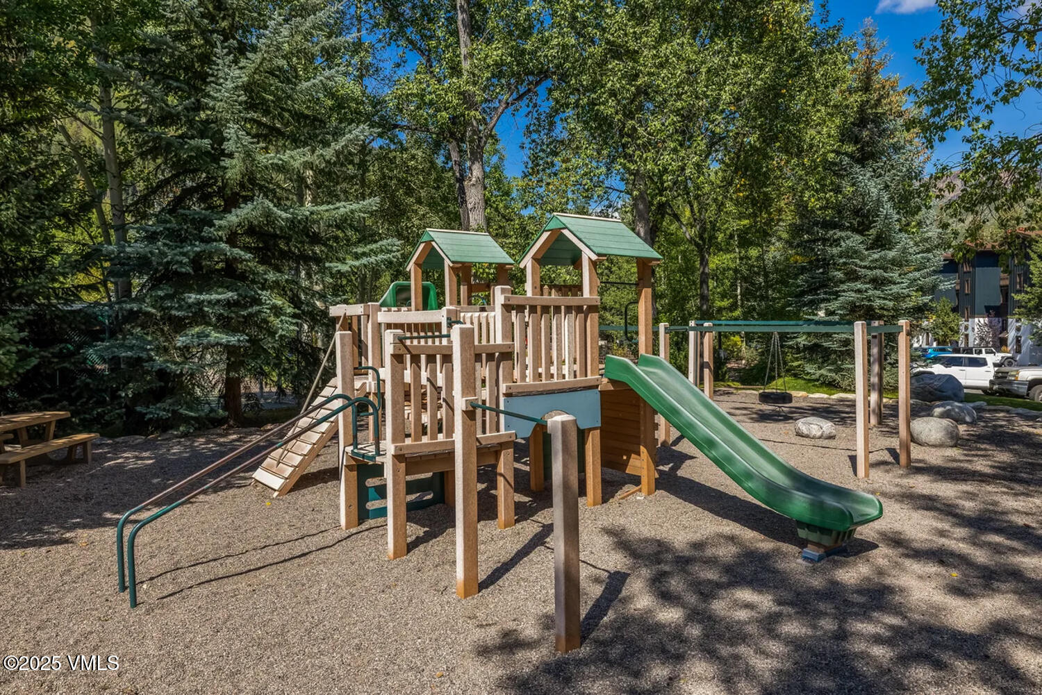 4650 Vail Racquet Club Drive, Unit 21 Vail, CO 81657 - Photo 25 of 29 a view of a chair and tables with the trees in the background