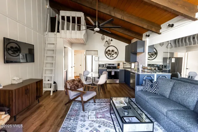 a living room with furniture and a clock