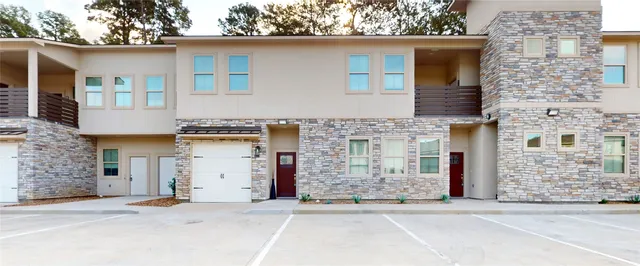 a front view of a house with barbeque oven and outdoor seating