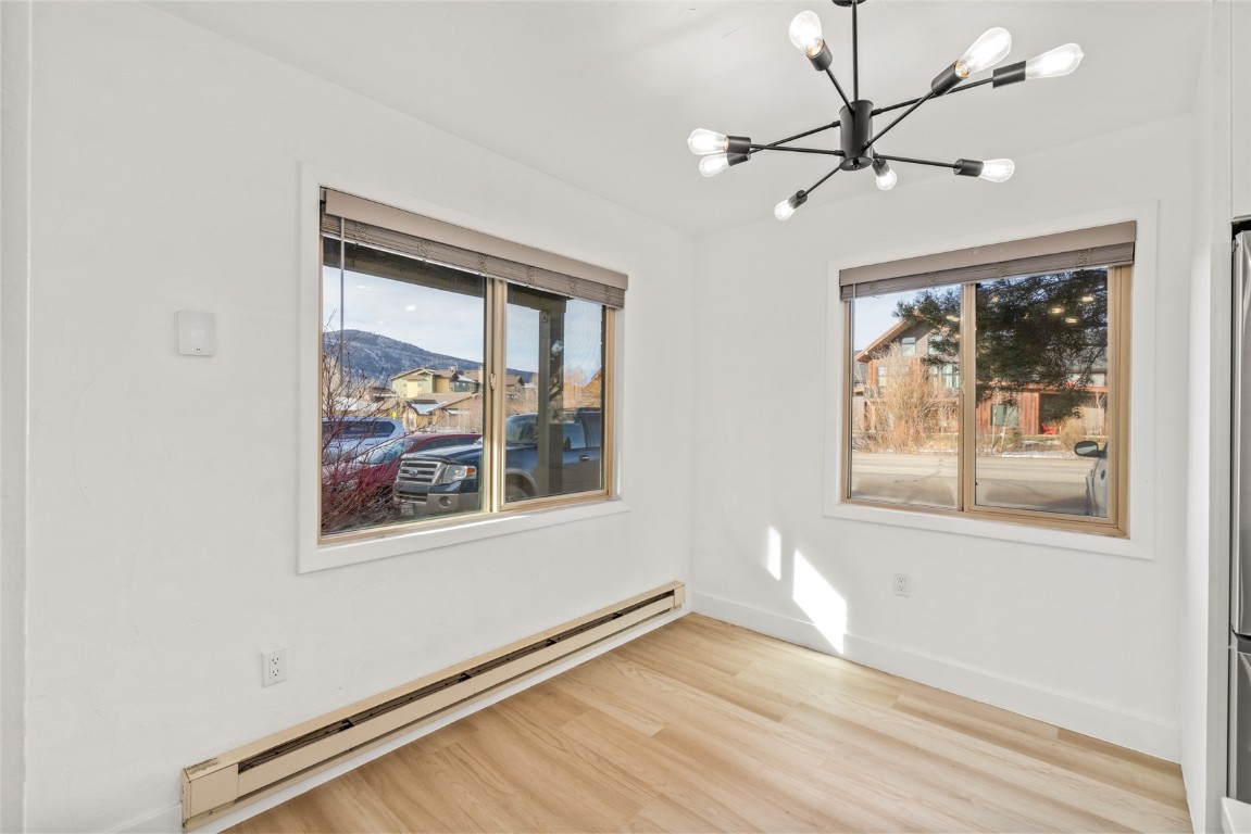 1375 Walton Creek Road, Unit 7 Steamboat Springs, CO 80487 - Photo 11 of 21 a view of an empty room with a window and wooden floor