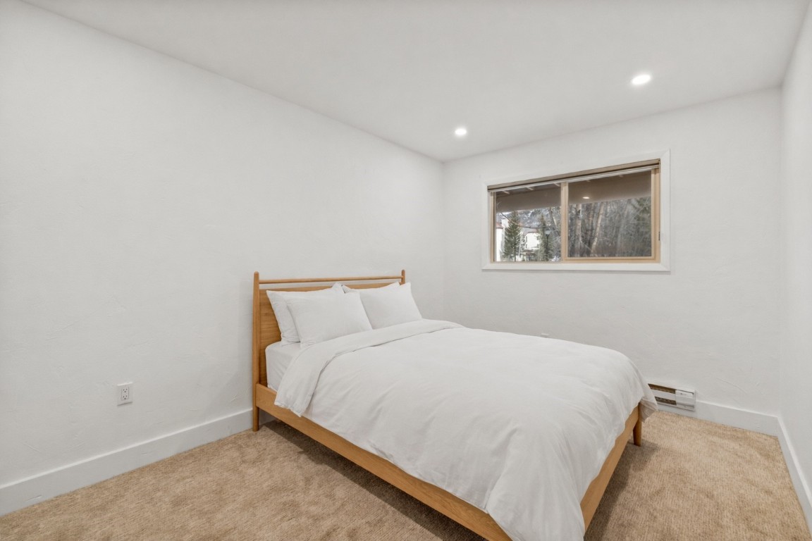 1375 Walton Creek Road, Unit 7 Steamboat Springs, CO 80487 - Photo 16 of 21 a large bed in a bedroom next to a window
