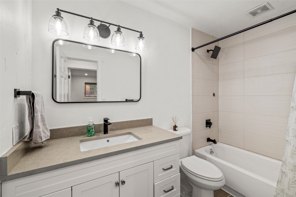 1375 Walton Creek Road, Unit 7 Steamboat Springs, CO 80487 - Photo 17 of 21 a bathroom with a granite countertop sink a toilet and a mirror