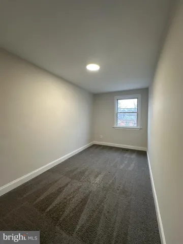 a view of an empty room and a window