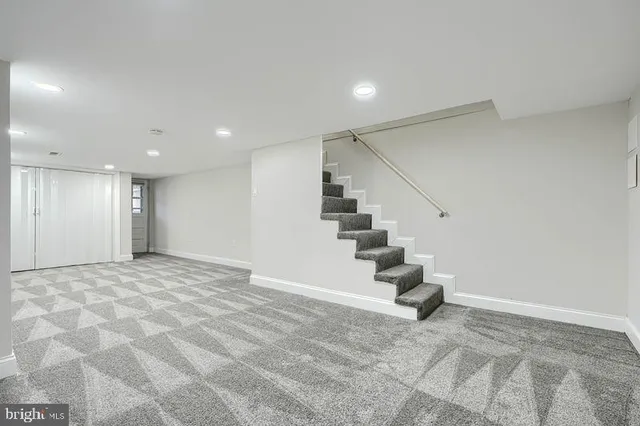 a view of an empty room with stairs and stairs