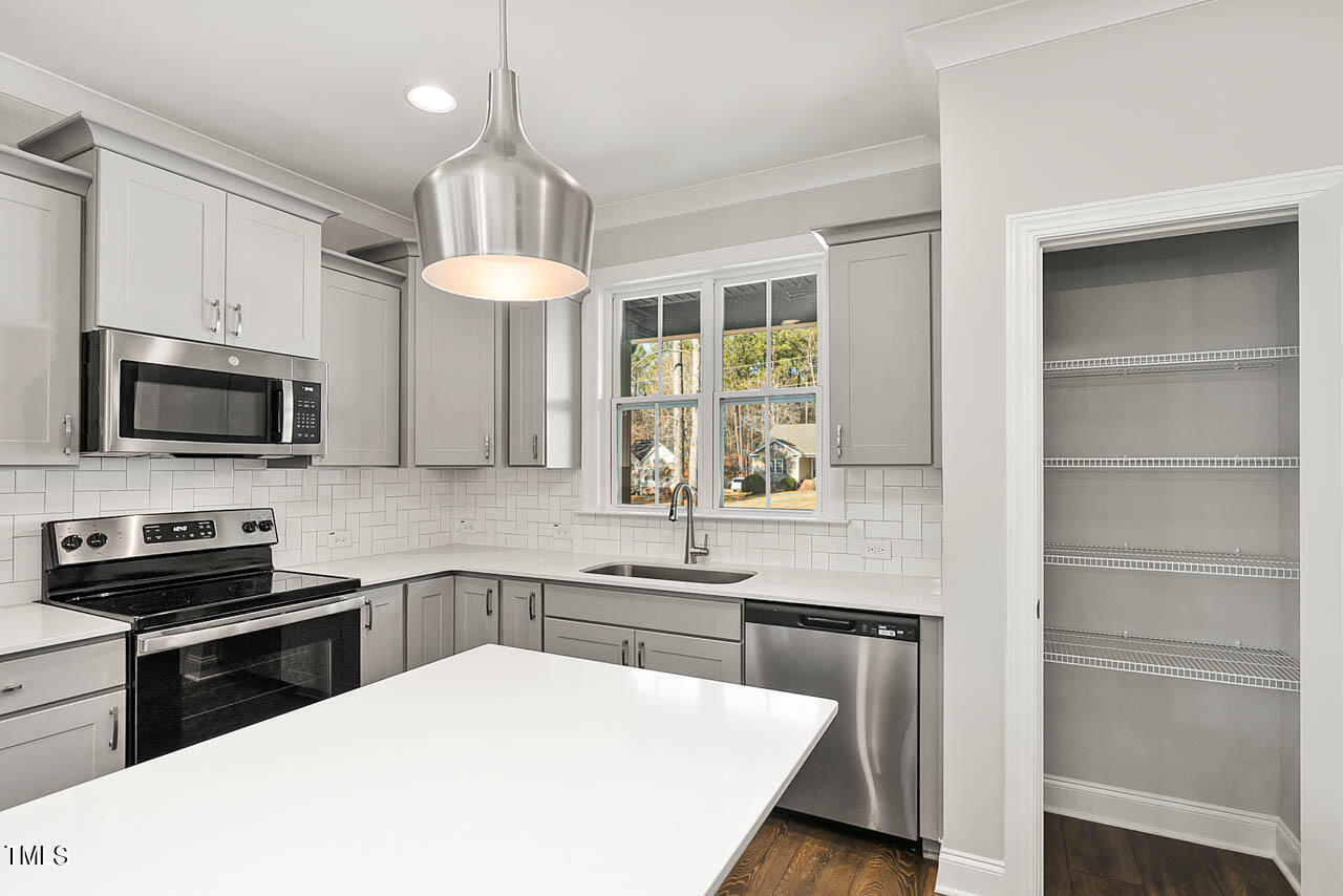 138 Rawhide Drive Spring Hope, NC 27882 - Photo 3 of 32 a kitchen with stainless steel appliances a stove a sink and microwave