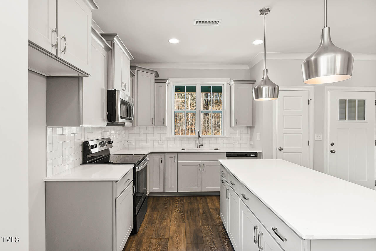 138 Rawhide Drive Spring Hope, NC 27882 - Photo 4 of 32 a kitchen with a sink stove and wooden floor