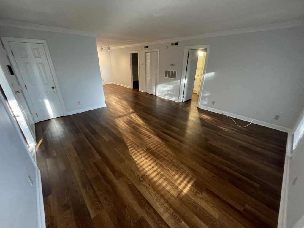 Undisclosed Address Raleigh, NC 27606 - Photo 2 of 14 a view of empty room with wooden floor