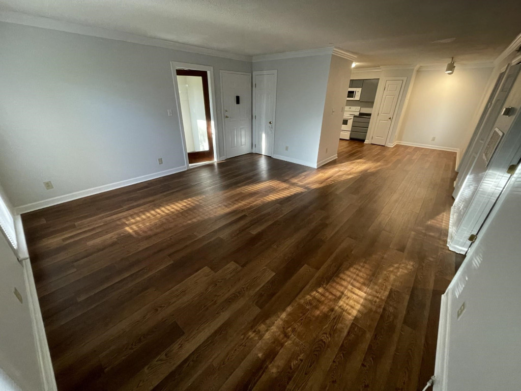 Undisclosed Address Raleigh, NC 27606 - Photo 3 of 14 a view of empty room with wooden floor