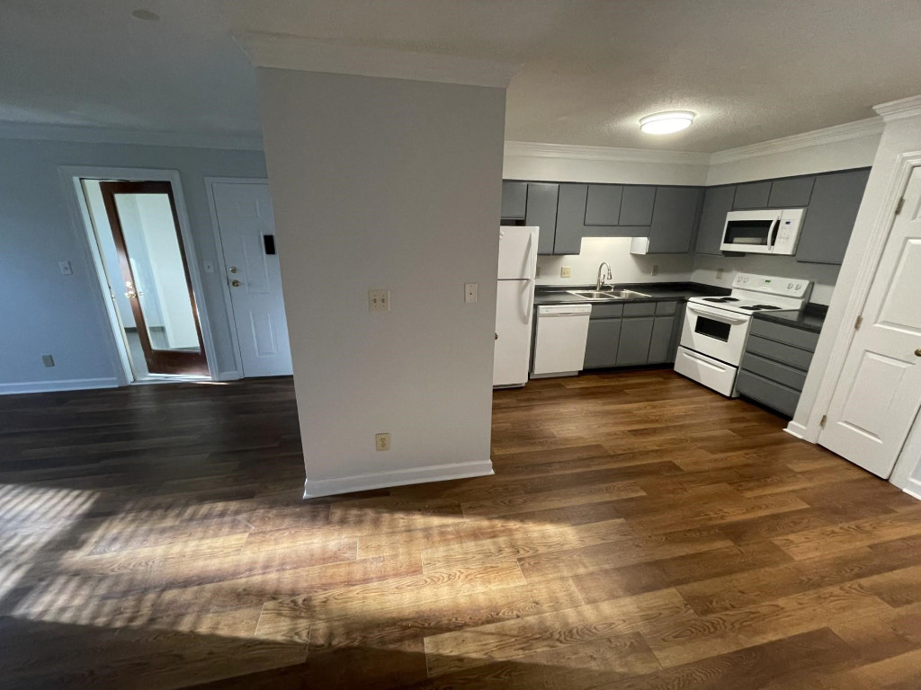 Undisclosed Address Raleigh, NC 27606 - Photo 4 of 14 a kitchen with stainless steel appliances wooden floor and cabinets