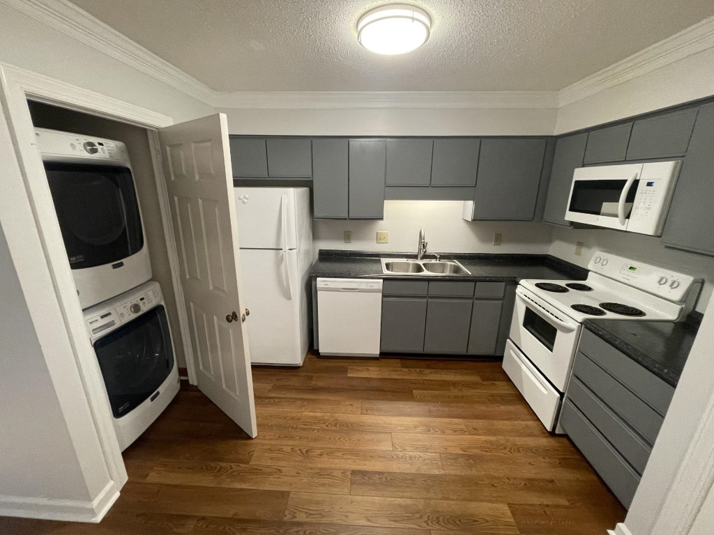 Undisclosed Address Raleigh, NC 27606 - Photo 6 of 14 a kitchen with stainless steel appliances a stove a sink and a microwave