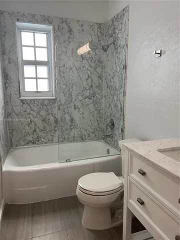 a bathroom with a bathtub and a toilet