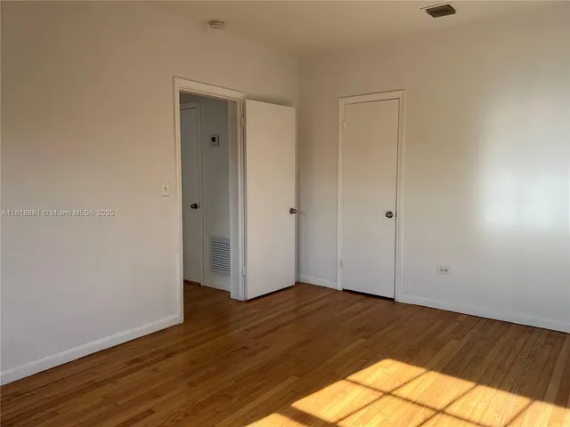 a view of a room with wooden floor