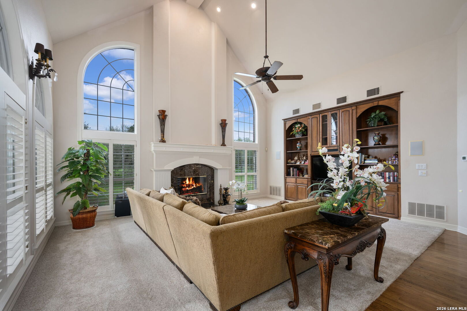 8040 Rolling Acres Trail Fair Oaks Ranch, TX 78015 - Photo 17 of 50 a living room with furniture a fireplace and potted plants