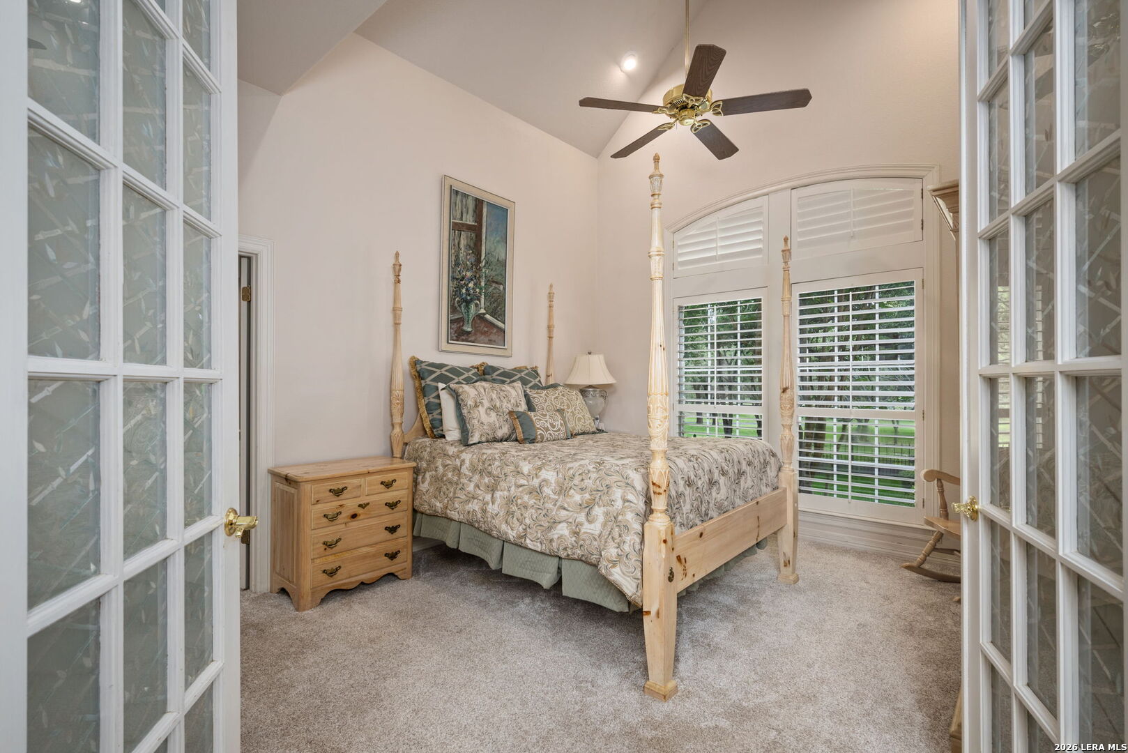 8040 Rolling Acres Trail Fair Oaks Ranch, TX 78015 - Photo 18 of 50 a bedroom with a bed chandelier and a window