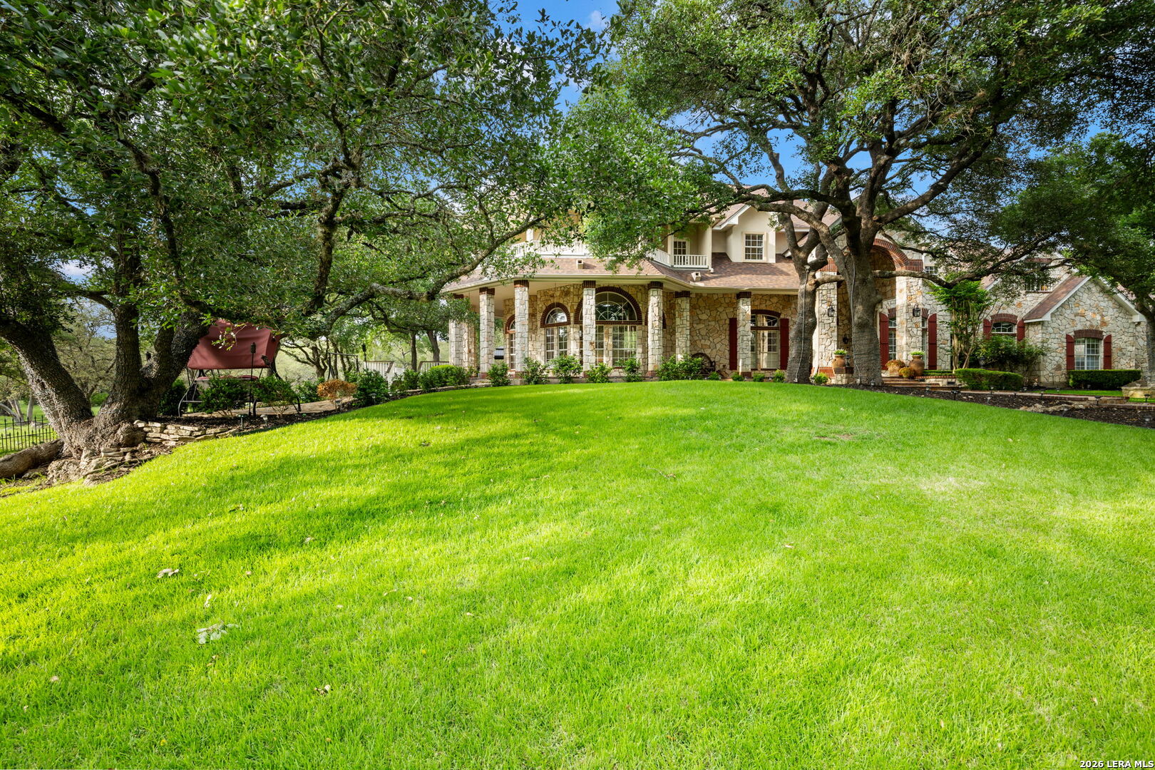 8040 Rolling Acres Trail Fair Oaks Ranch, TX 78015 - Photo 2 of 50 a front view of a house with a garden