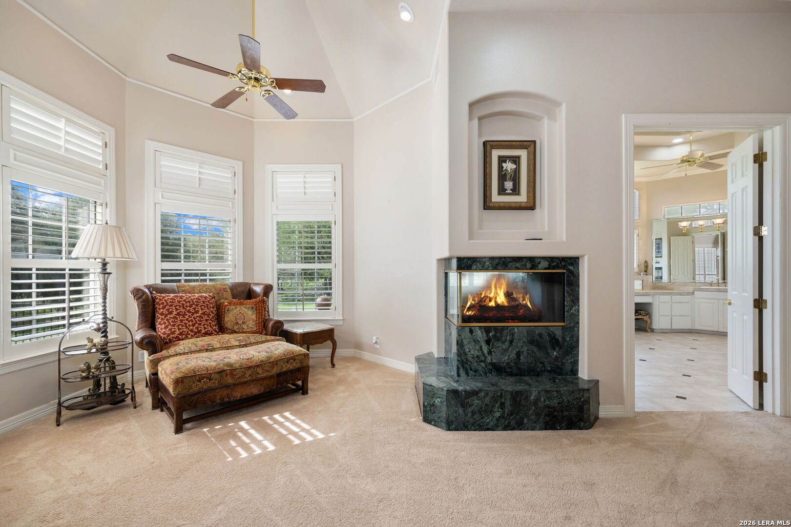 8040 Rolling Acres Trail Fair Oaks Ranch, TX 78015 - Photo 22 of 50 a living room with furniture and a fireplace