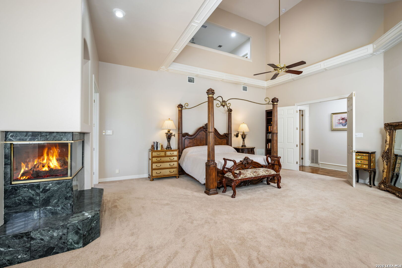 8040 Rolling Acres Trail Fair Oaks Ranch, TX 78015 - Photo 23 of 50 a bedroom with furniture and a chandelier