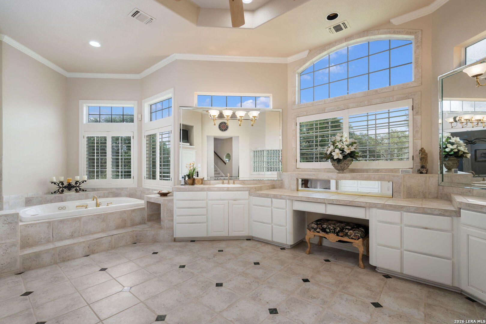 8040 Rolling Acres Trail Fair Oaks Ranch, TX 78015 - Photo 25 of 50 a large bathroom with a sink mirror and a bath tub