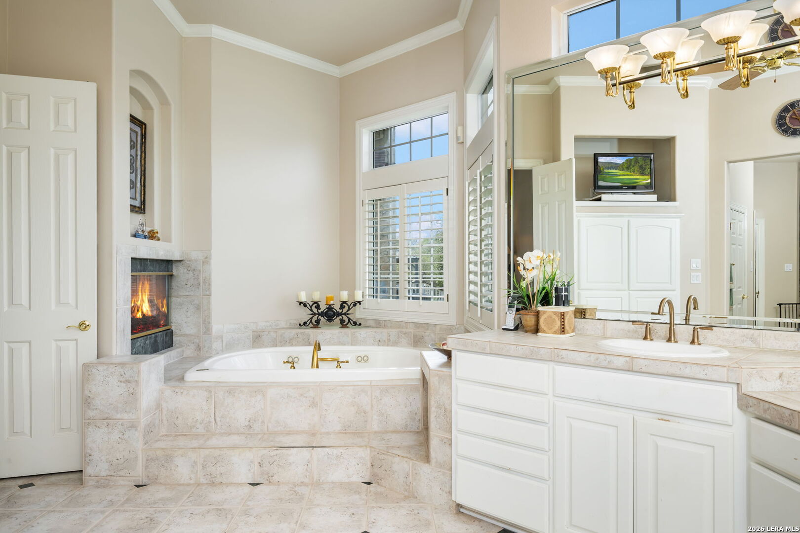 8040 Rolling Acres Trail Fair Oaks Ranch, TX 78015 - Photo 26 of 50 a bathroom with a double vanity sink a mirror and a bathtub