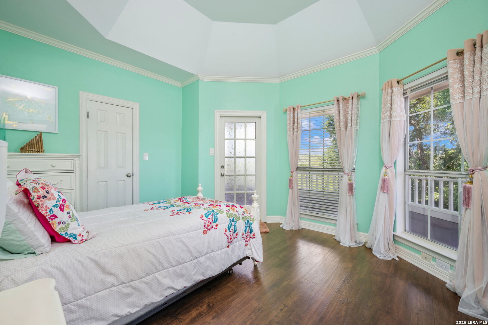 8040 Rolling Acres Trail Fair Oaks Ranch, TX 78015 - Photo 37 of 50 a bedroom with a bed and wooden floor