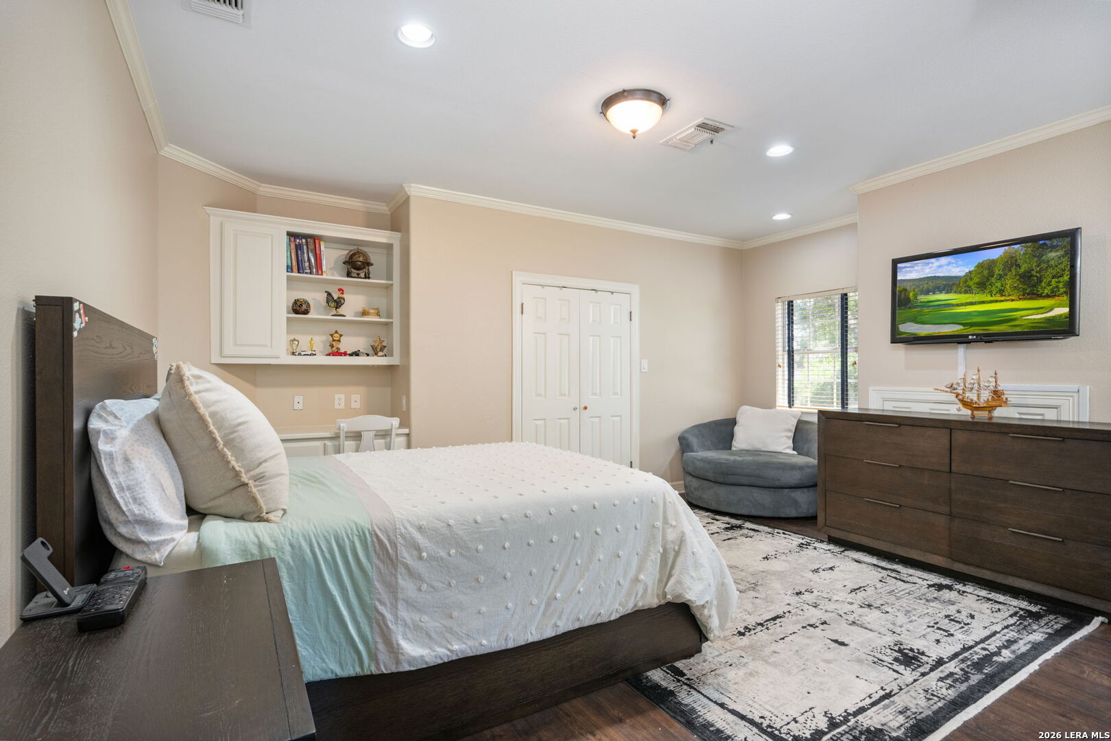 8040 Rolling Acres Trail Fair Oaks Ranch, TX 78015 - Photo 39 of 50 a bedroom with a bed a couch and a flat screen tv