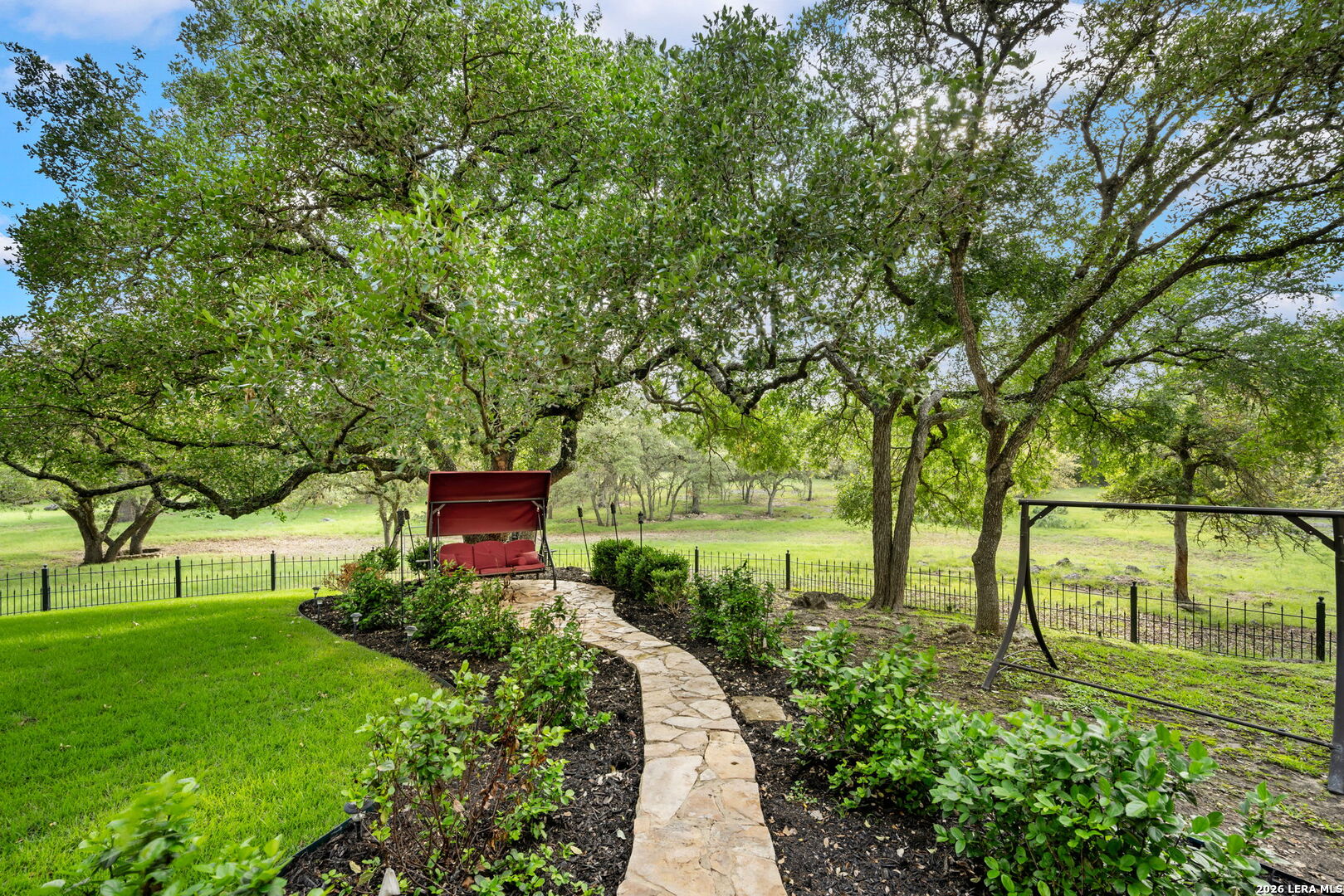 8040 Rolling Acres Trail Fair Oaks Ranch, TX 78015 - Photo 44 of 50 a view of a garden with a bench