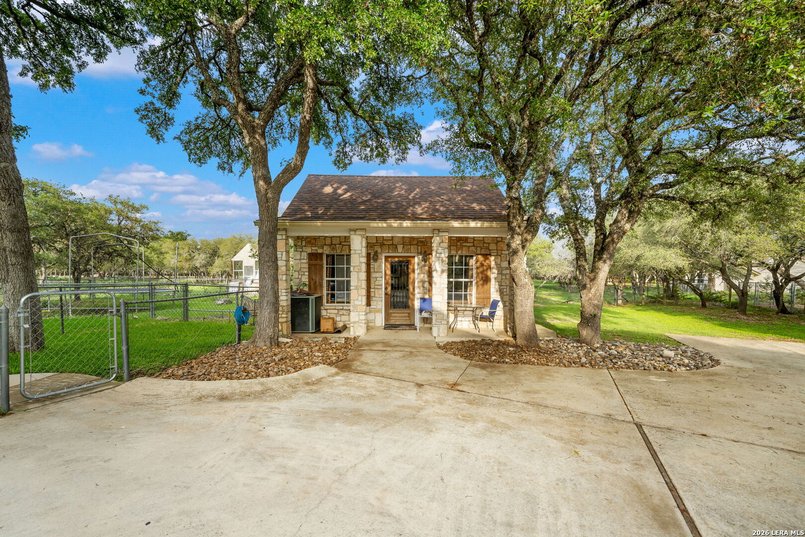 8040 Rolling Acres Trail Fair Oaks Ranch, TX 78015 - Photo 45 of 50 a view of a house with a large tree and a yard