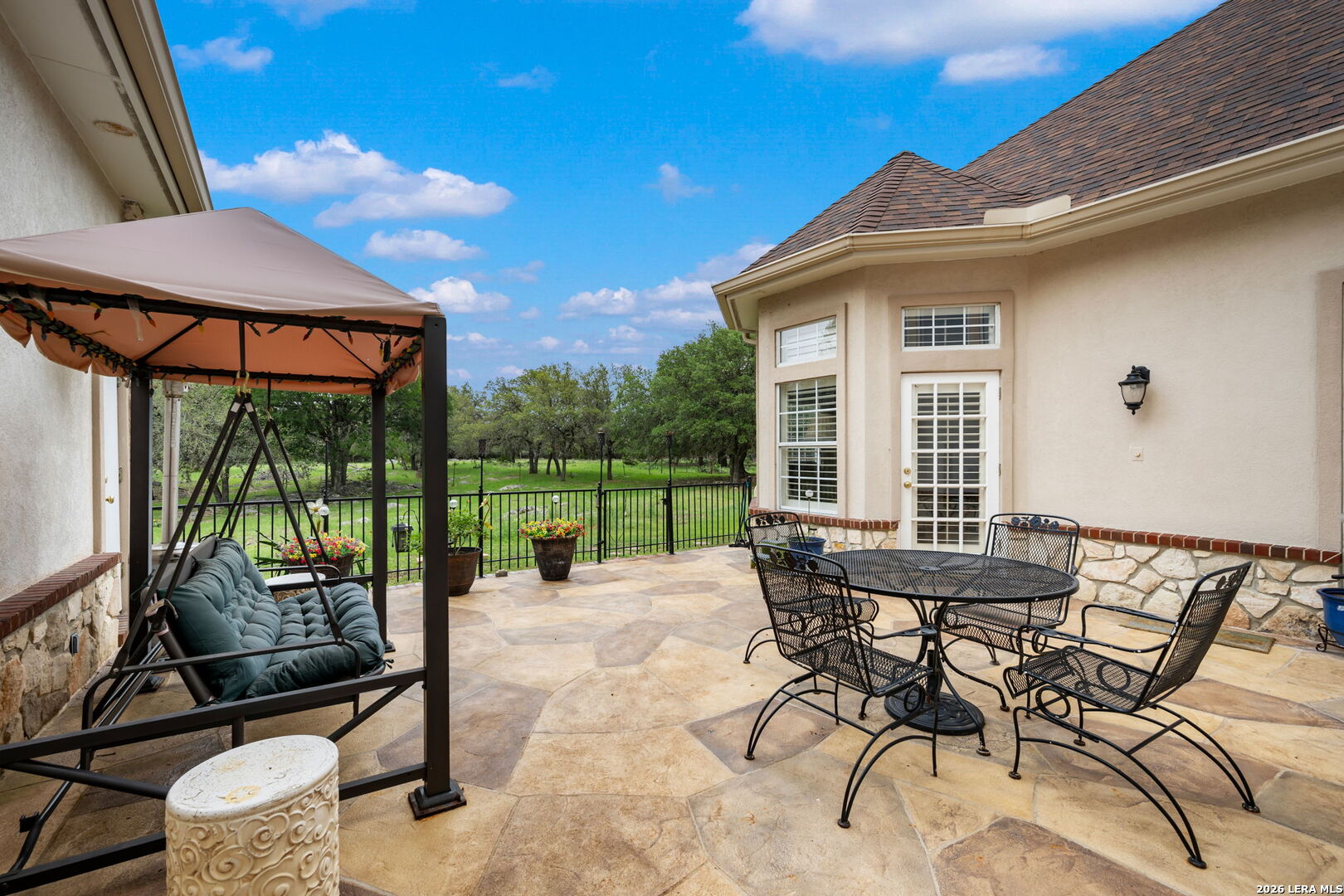 8040 Rolling Acres Trail Fair Oaks Ranch, TX 78015 - Photo 46 of 50 a patio with yard glass top table and chairs