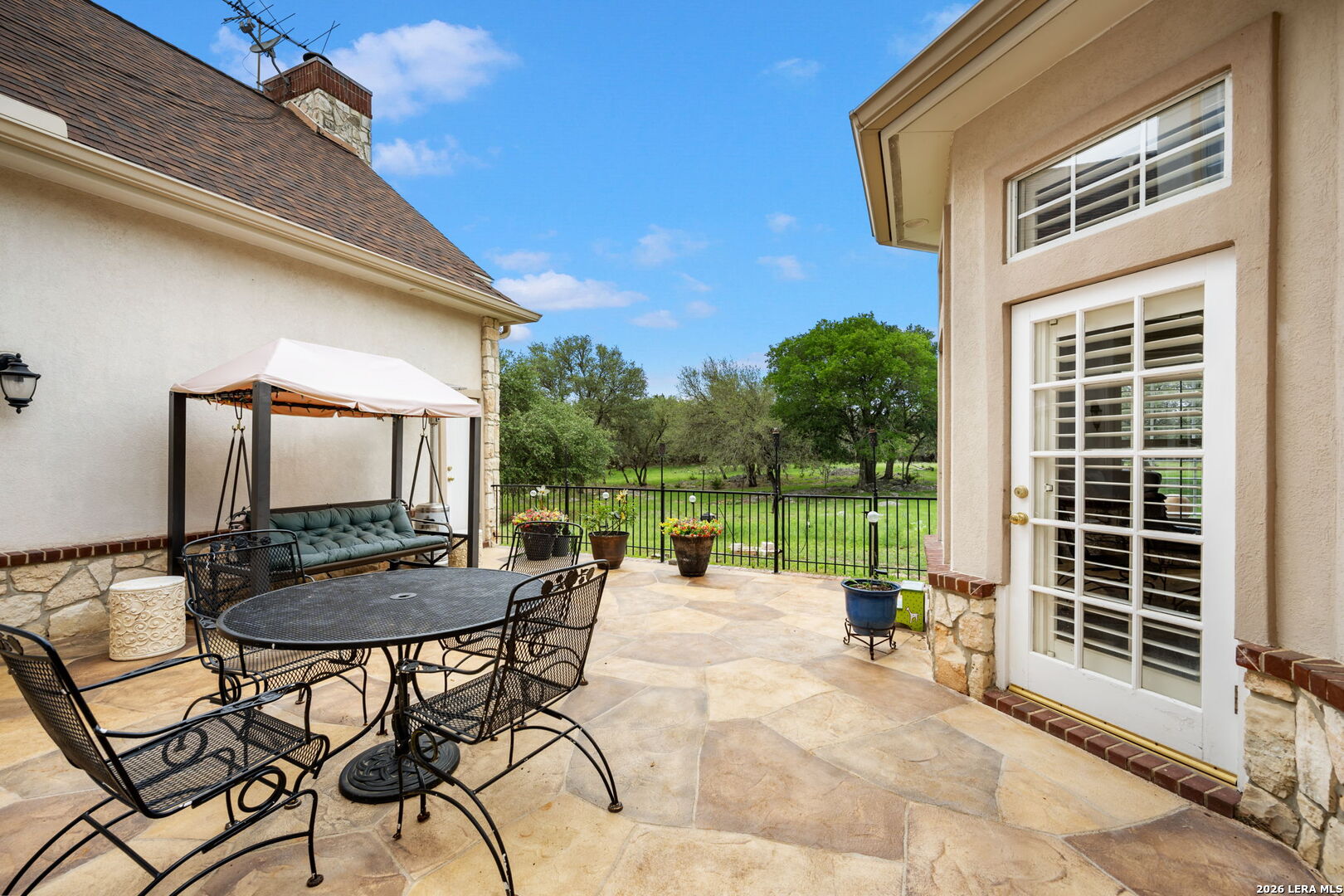 8040 Rolling Acres Trail Fair Oaks Ranch, TX 78015 - Photo 47 of 50 a backyard of a house with barbeque oven table and chairs