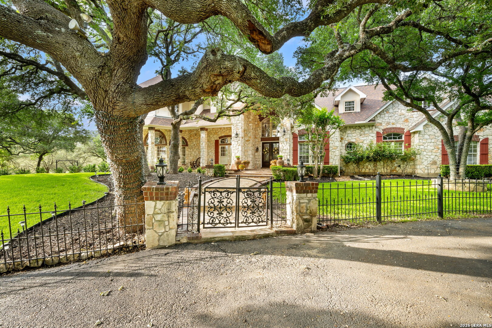 8040 Rolling Acres Trail Fair Oaks Ranch, TX 78015 - Photo 50 of 50 a view of a house with a large tree and garden