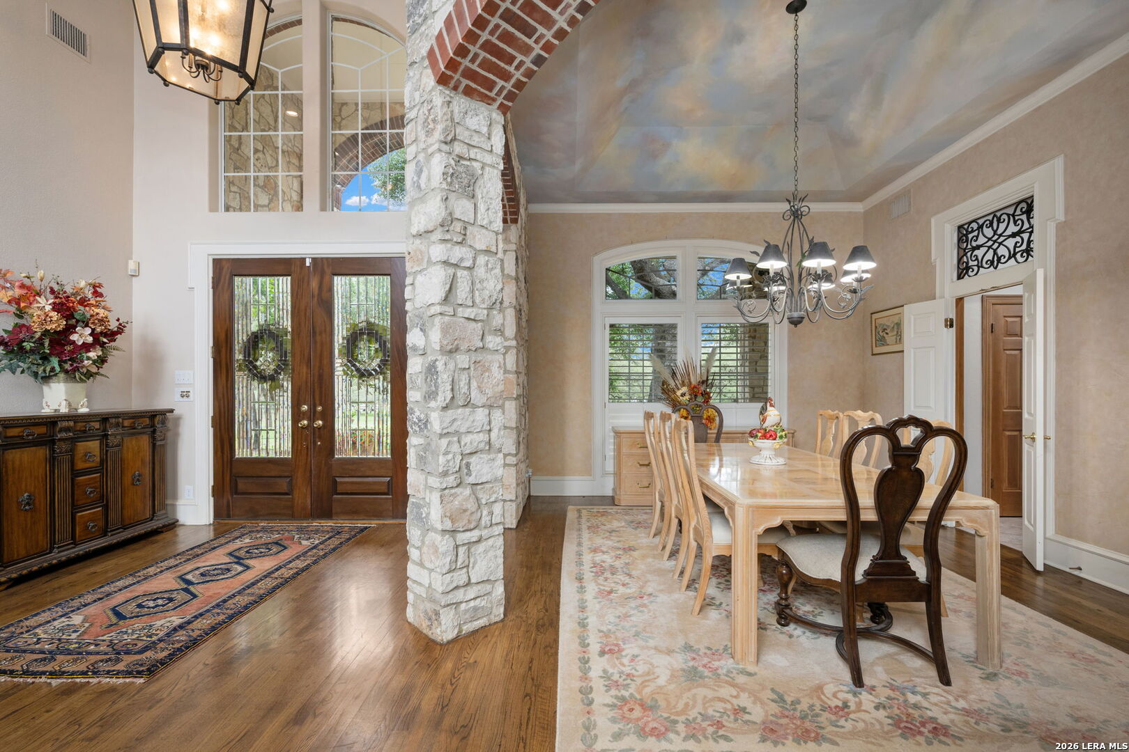 8040 Rolling Acres Trail Fair Oaks Ranch, TX 78015 - Photo 6 of 50 a dining room with furniture a chandelier and wooden floor