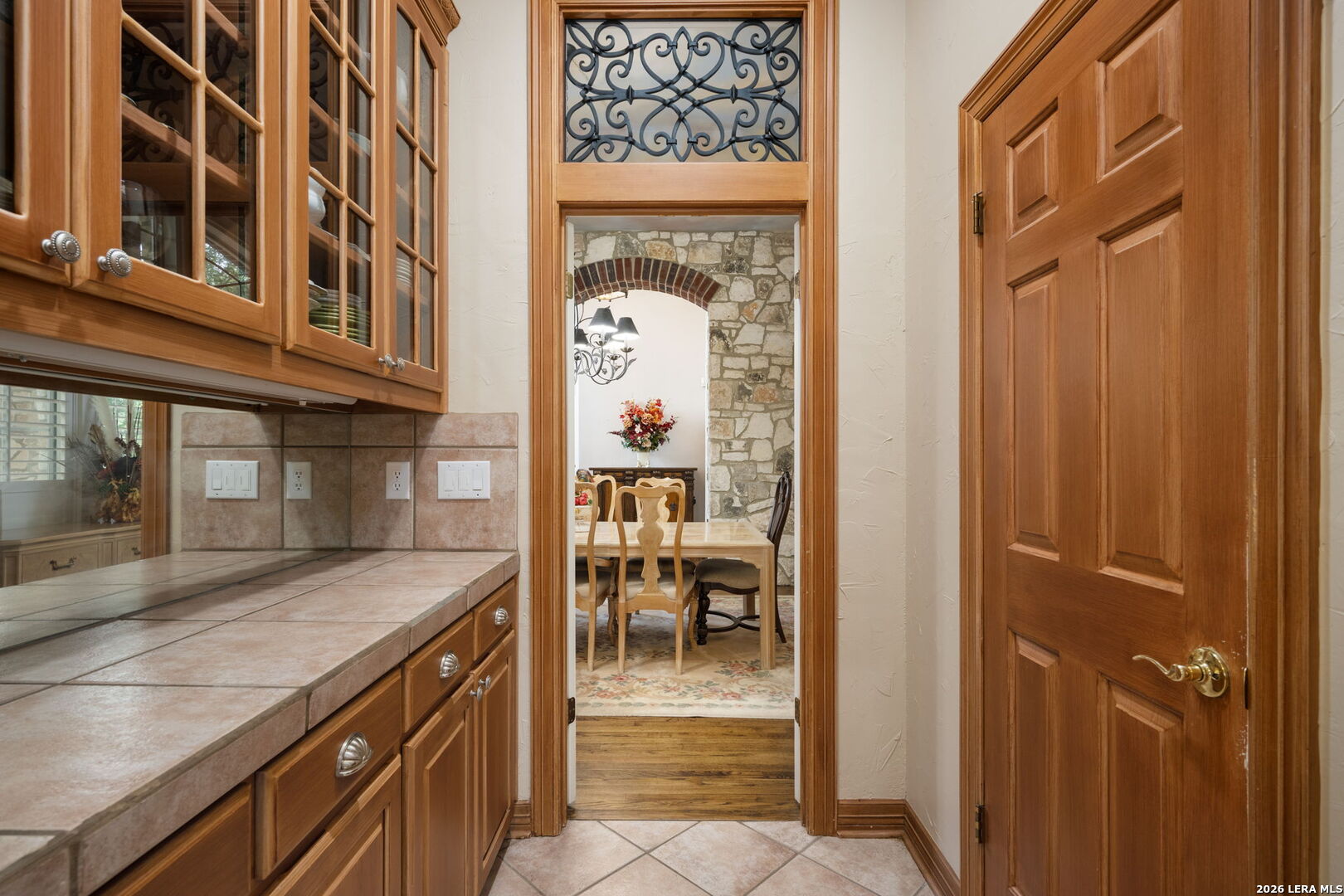 8040 Rolling Acres Trail Fair Oaks Ranch, TX 78015 - Photo 9 of 50 a view of a hallway with a dining table and chairs