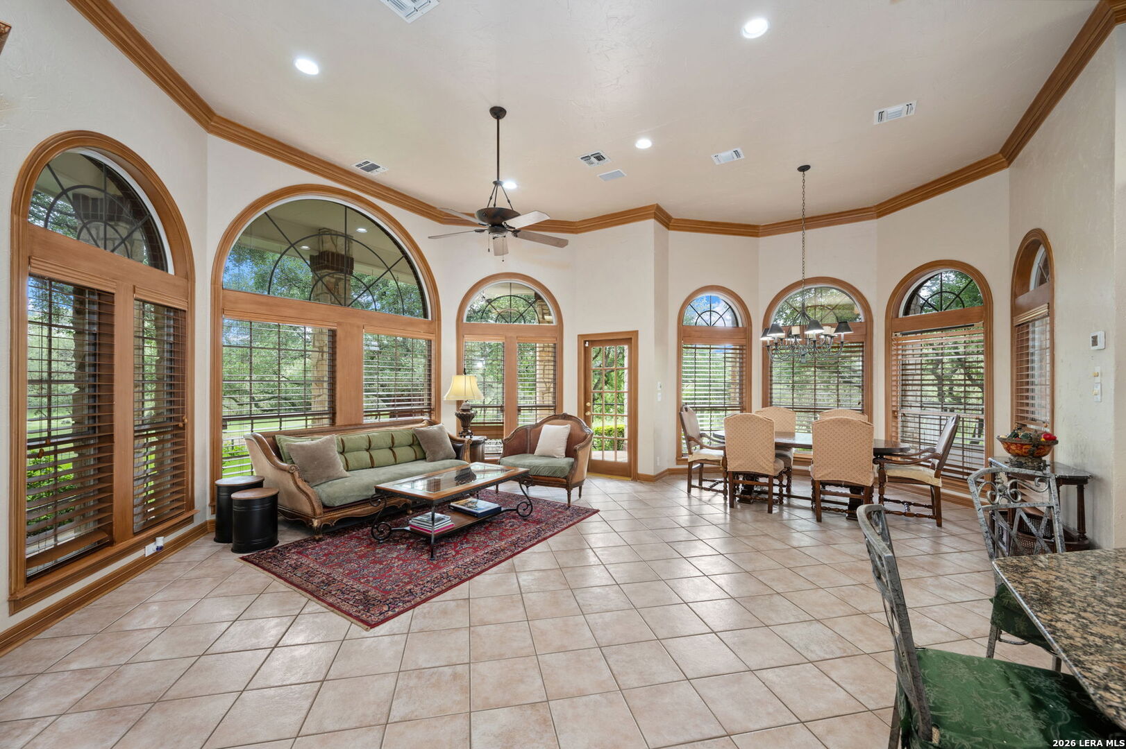 8040 Rolling Acres Trail Fair Oaks Ranch, TX 78015 - Photo 10 of 50 a living room with couches a table and a large window with garden view