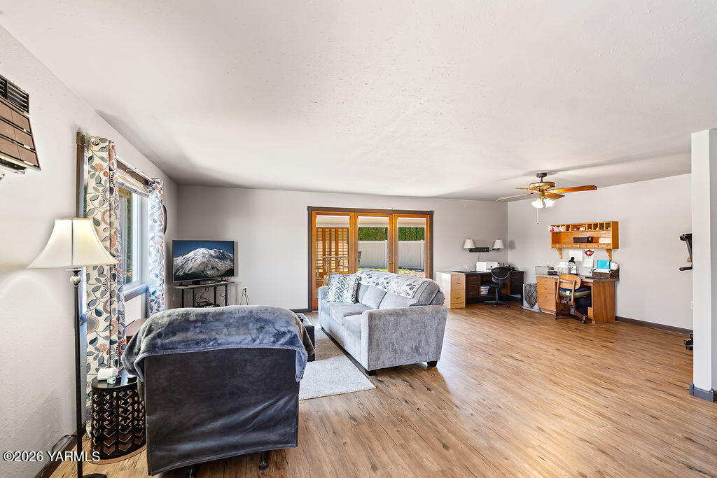 3003 South 79th Avenue Yakima, WA 98903 - Photo 11 of 32 a living room with furniture and a flat screen tv
