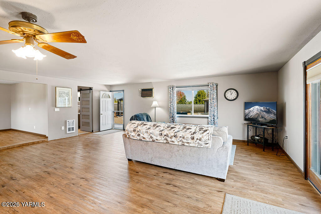 3003 South 79th Avenue Yakima, WA 98903 - Photo 13 of 32 a bedroom with a bed and wooden floor