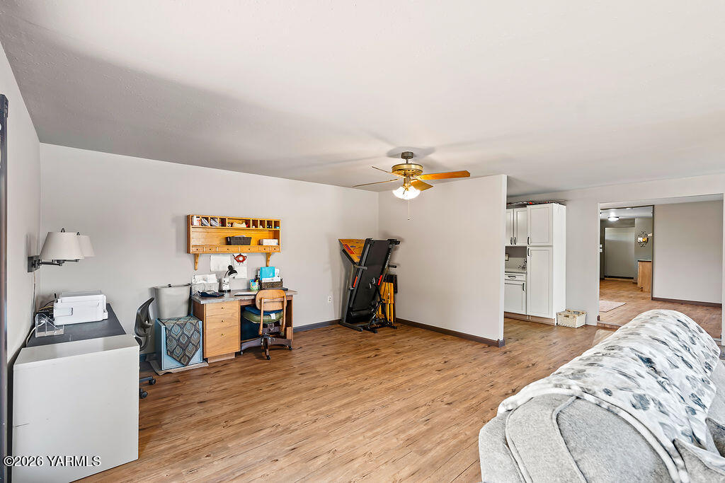 3003 South 79th Avenue Yakima, WA 98903 - Photo 14 of 32 a bedroom with furniture and a wooden floor