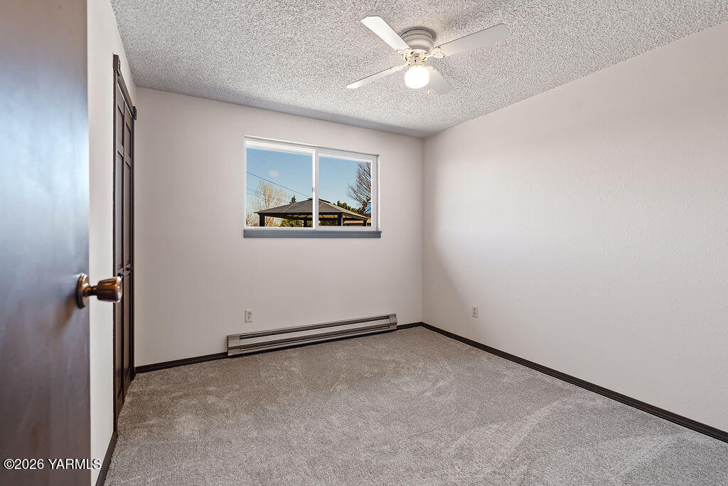 3003 South 79th Avenue Yakima, WA 98903 - Photo 18 of 32 an empty room with windows and fan