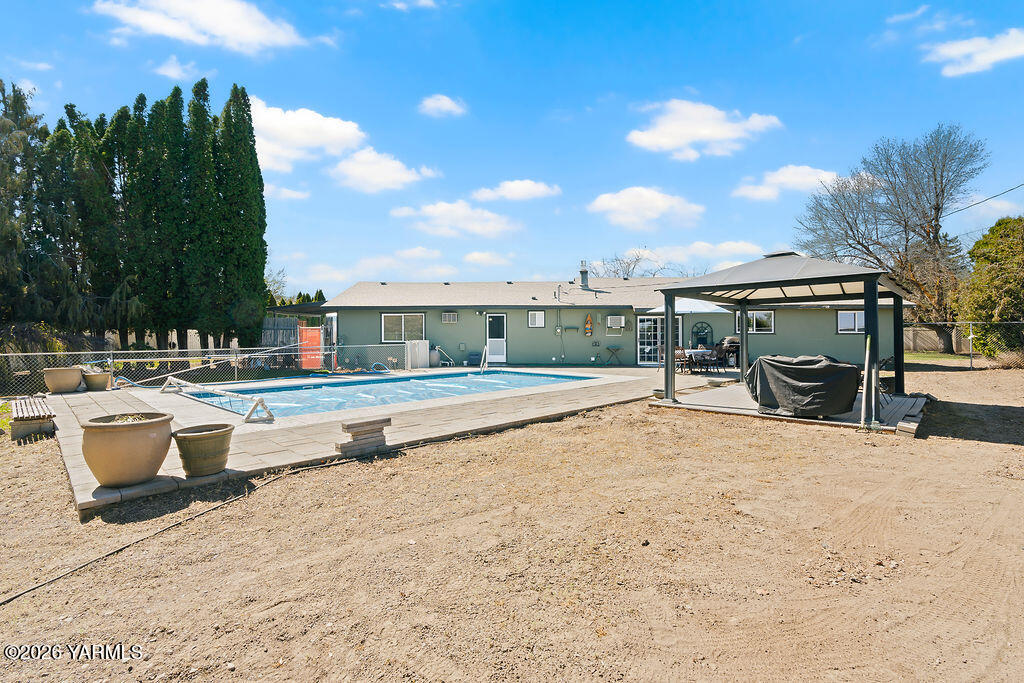 3003 South 79th Avenue Yakima, WA 98903 - Photo 23 of 32 a view of swimming pool with seating area and barbeque oven