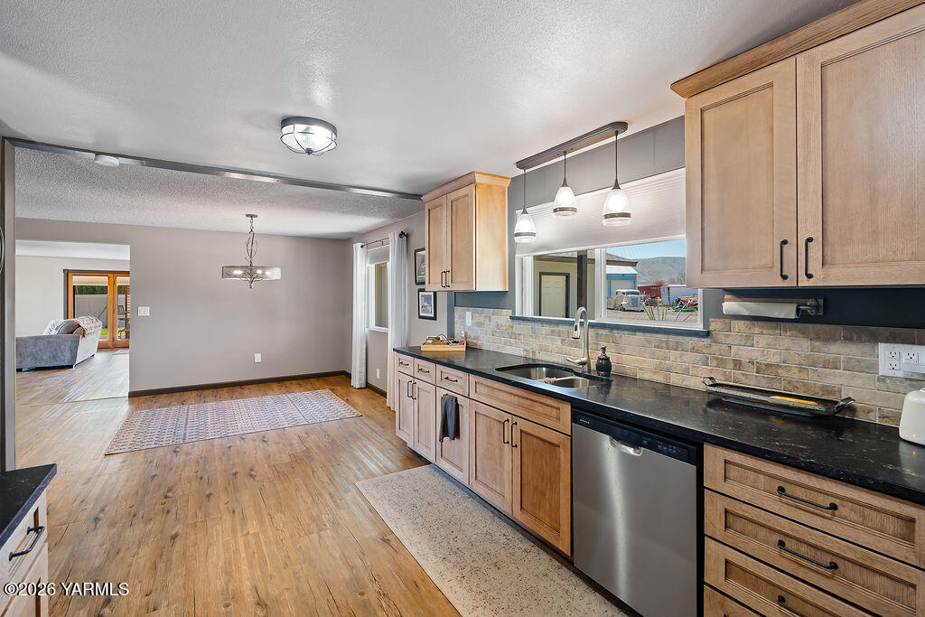3003 South 79th Avenue Yakima, WA 98903 - Photo 6 of 32 a kitchen with stainless steel appliances granite countertop wooden cabinets and a counter top space