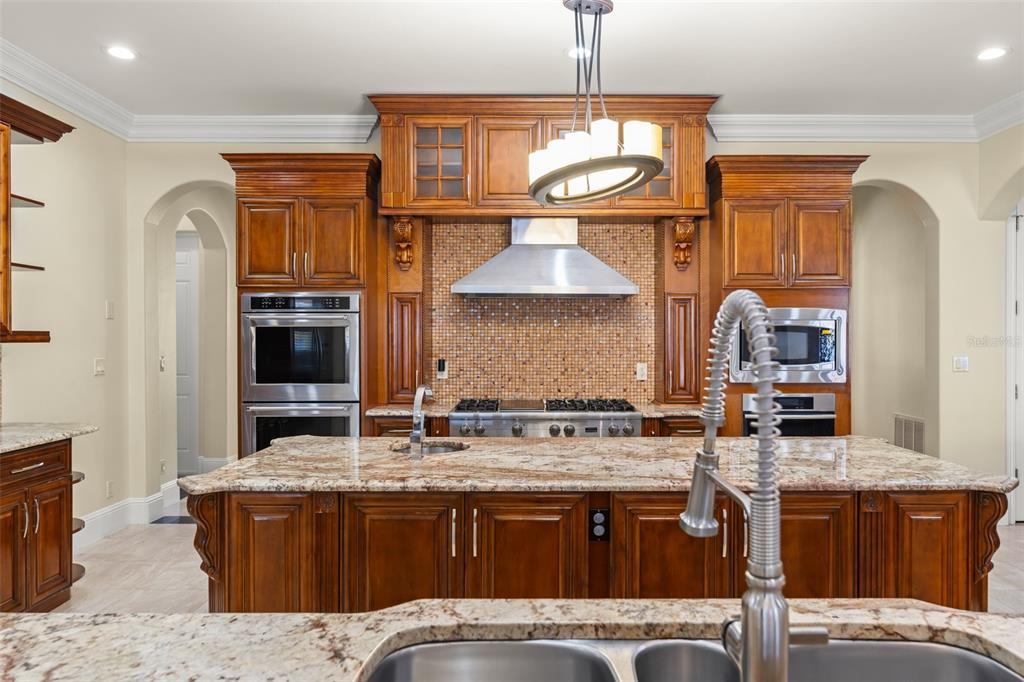 9575 Westover Roberts Road Windermere, FL 34786 - Photo 20 of 95 a kitchen with stainless steel appliances granite countertop a stove a sink dishwasher and a refrigerator