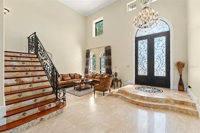 a living room with furniture a flat screen tv and a large window