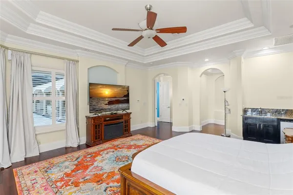 a bedroom with a bed and a painting on the wall