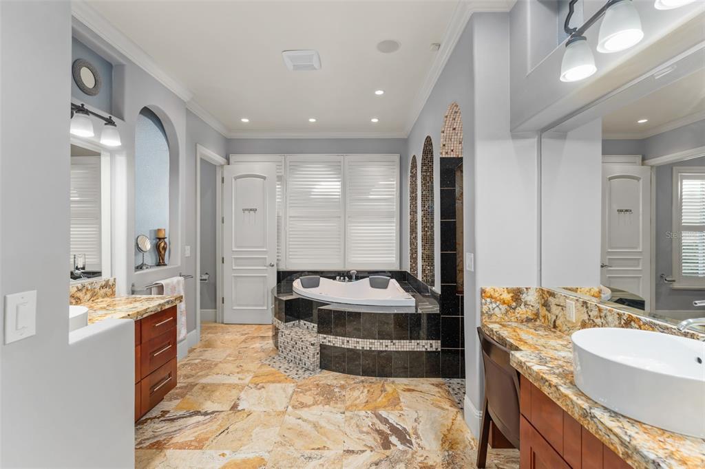 9575 Westover Roberts Road Windermere, FL 34786 - Photo 34 of 95 a large spacious bathroom with a double vanity sink a mirror and a bathtub