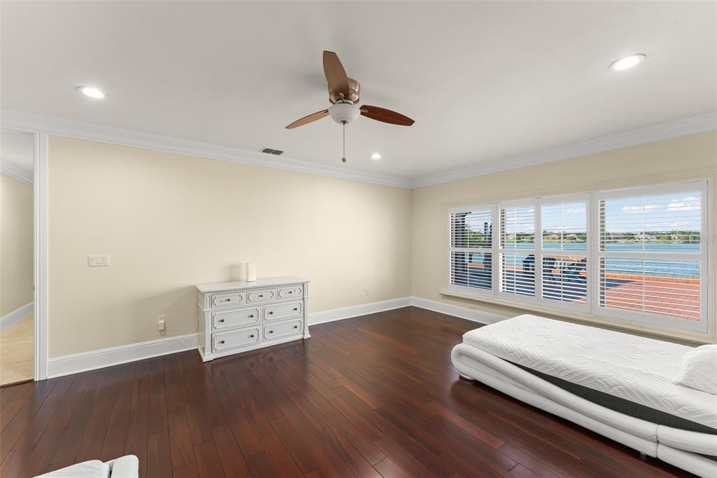 9575 Westover Roberts Road Windermere, FL 34786 - Photo 41 of 95 a spacious bedroom with a bed and a large window