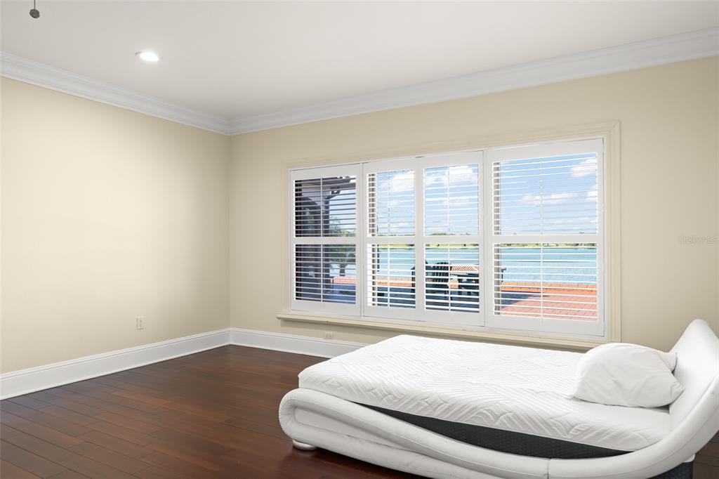9575 Westover Roberts Road Windermere, FL 34786 - Photo 42 of 95 a bed sitting in a bedroom next to a window