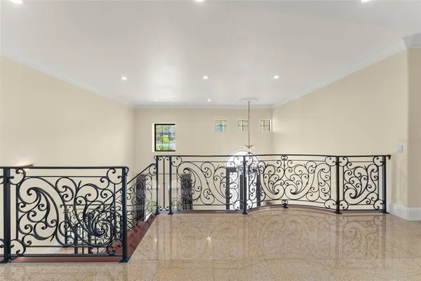 a front view of a house with a yard and potted plants